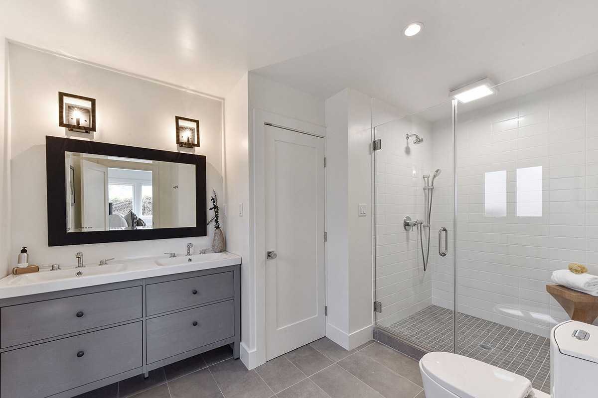 Primary bathroom suite with glass shower and custom tile