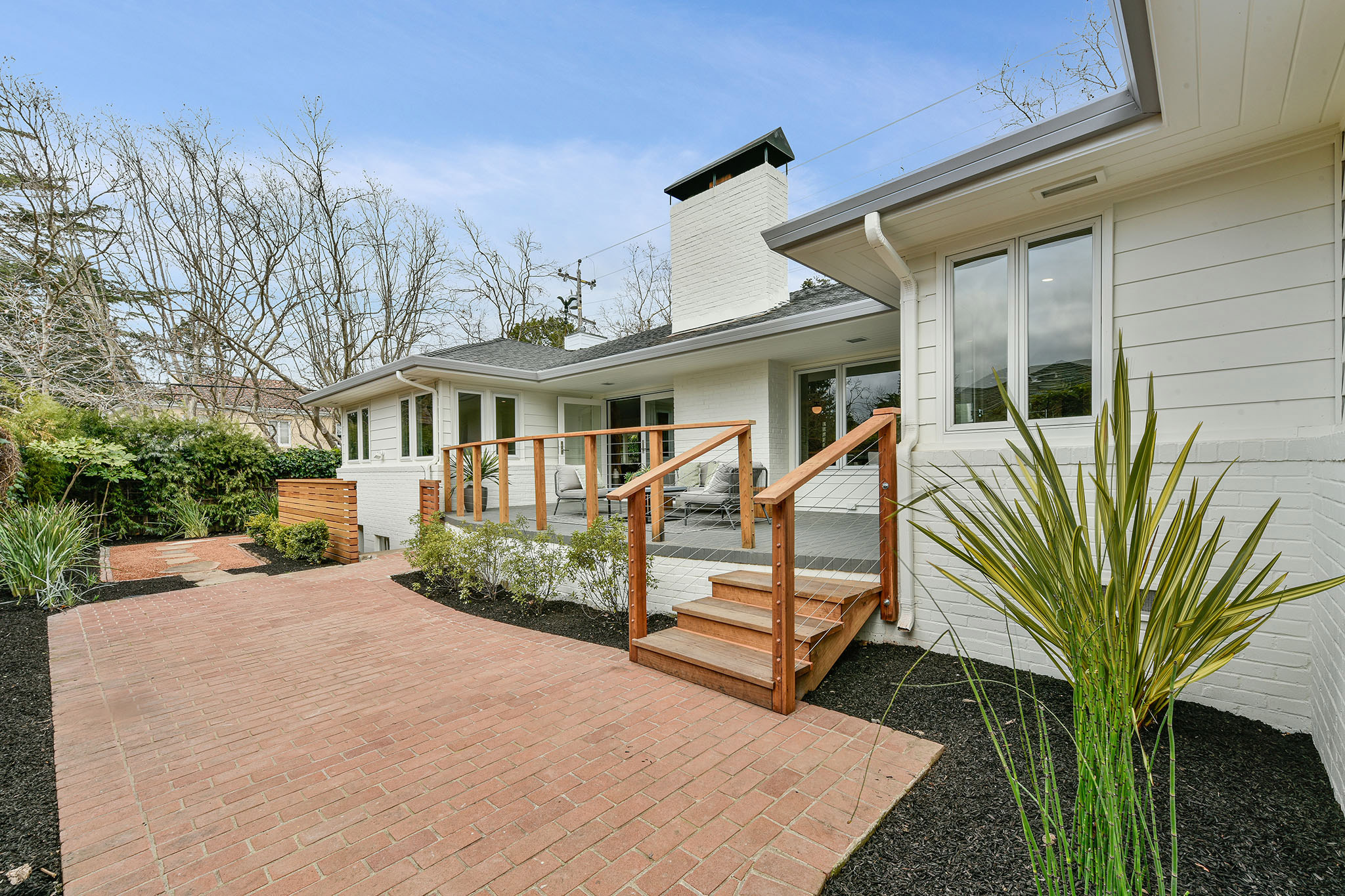 Rear exterior view, showing a large yard and patio