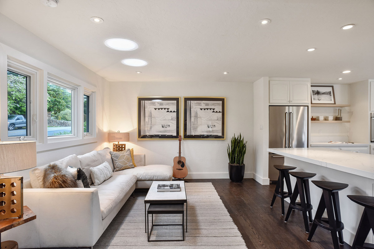 View of a sitting area near the kitchen with large windows and lots of natural light